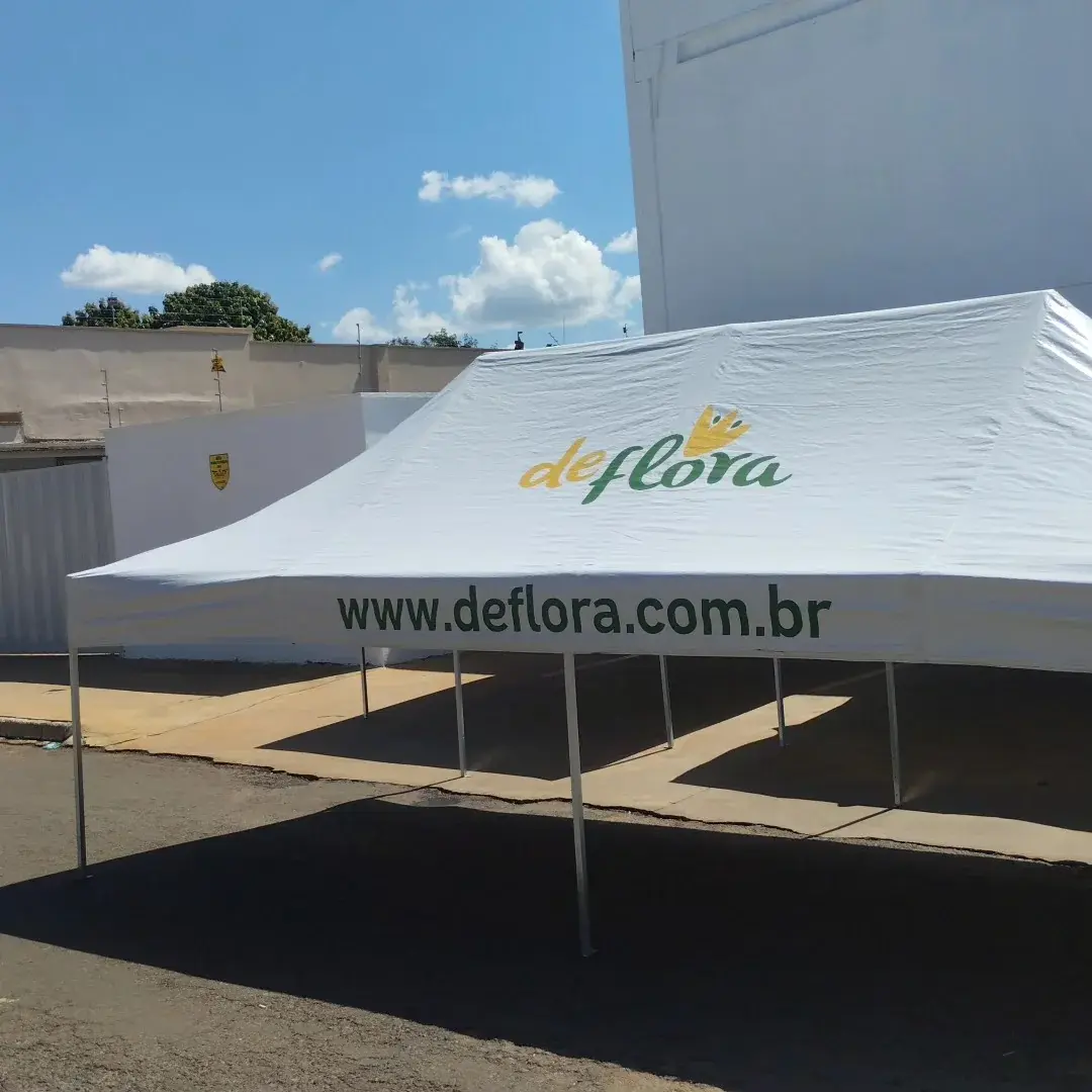 Tenda branca com a marca deFlora impressa no teto e na faixa frontal